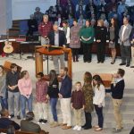 Family and colleagues of Wayne Jenkins stand in front of the altar and on stage during a special presentation honoring the long-time evangelism director for Louisiana Baptists.