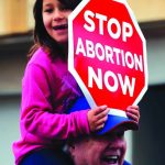 A young girl sits on the shoulders of her dad as they participate in the Louisiana Life March North which began at Bossier City’s Louisiana Boardwalk and ended at Shreveport’s Festival Plaza. Doug Collier photo
