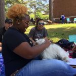 A Louisiana College student enjoys a break from final exams at the Paws Up event.