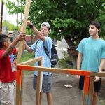 BCM students and Mexican young men work together on a construction project.