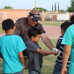 Steve Masters, director of the LSU BCM, offers tips on golf to young men in Mexico.