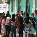Students share a smile with children during a Bible club.