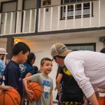 Children talk to a BCM student leading a sports clinic in Mexico. Ten people accepted Christ by participating in the clinic.