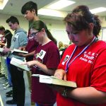Students look up a Scripture passage during the 2018 Louisiana Baptist State Bible Drill competition April 28 at First Baptist Church in Pineville. The participants in the Bible drills and Speakers’ Tournaments go through a three-step process which begins in the church before moving on to the district level and then finally advancing to the state level.