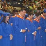 Students pray before commencement ceremonies begin.