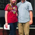 Hannah James stands on stage beside Louisiana Baptists Youth Ministry Strategist Steve Maltempi. James, who is a member of Fellowship Church in Greenwell Springs, was chosen to represent Louisiana Baptist at the National Youth Bible Drill Tournament.