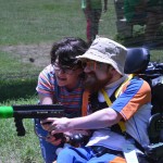 A buddy and her Champions Camp participant take aim at the competition in bazooka ball.