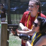A buddy and her Champions Camp participant aim at a player in bazooka ball.