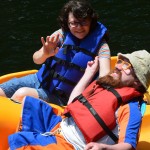 A buddy and her Champions Camp participant ride on the paddle boat.