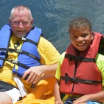 A buddy and his Champions Camp participant enjoyed a ride on the paddle boat in June 2018. File photo