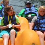 Champions Camp participants and their buddies enjoy a ride on the paddle boat.