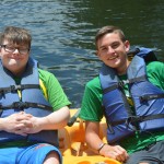 Camper Jacob Hall and his buddy Preston Fuqua relax in a paddle boat.