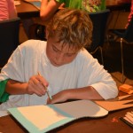 A Champions Camp participant enjoys completing his craft.
