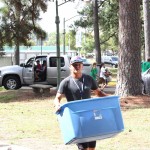 A student carries in a bin.