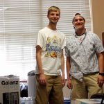 Students take a break from a busy day of moving into their dormitory.