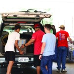 Several students unload belongings from the trunk of a vehicle during Louisiana College Move-In Day.