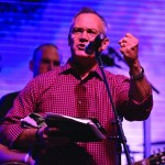 Rick Gage, founder of GO TELL Ministries, encourages the crowd to invite others to the remaining sessions of the Tomorrow's Hope Crusade.