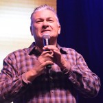 Evangelist Scott Camp encourages the crowd to share Christ with others.