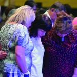 Tomorrow's Hope Crusade attendees pray during a time of invitation.