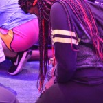 A student prays at the altar inside Guinn Auditorium.