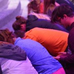 Students pray at the altar inside Guinn Auditorium.