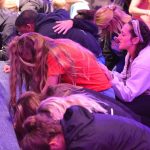 Students pray at the altar inside Guinn Auditorium.