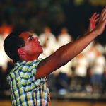 A man raises his hands during a time of worship.