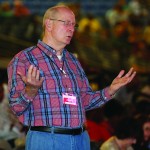 A man raises his hands during a time of worship.