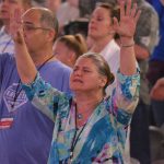 A woman raises her hands in praise during a Rush of Fools mini-concert. Brian Blackwell photo