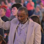A man raises his hands in praise during a Rush of Fools mini-concert. Brian Blackwell photo