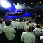A combined choir from central Louisiana churches sings during a time of worship at the first night of the Hope4U GO TELL Crusade at the Rapides Parish Coliseum in Alexandria.