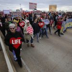Right to life supporters march across the Long-Allen Bridge between Shreveport and Bossier City during the Louisiana Life March North.