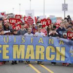 Right to life supporters march across the Long-Allen Bridge between Shreveport and Bossier City during the Louisiana Life March North.