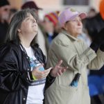 Supporters at the Louisiana Life March North lift their hands to heaven.