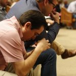Daniel Hernandez, (L) and (Brad Jurkovich) pray in their seats during the Call to Prayer IV at Broadmoor Baptist Church in Shreveport.