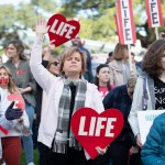 A woman lifts her hands to heaven at the Louisiana Life March South.
