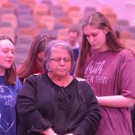 Students surround an ECON participant in a time of prayer.