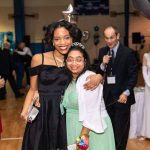 A special guest and her buddy enjoy a Night to Shine in Gonzales.