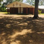 The first facility was a wooden building located not far from the present building. This 2-story structure was used until it burned in later years. The second building was erected across the road from where the present structure is located. It was a small box house with 12-inch vertical planks. In 1900, the congregation under the leadership of Pastor Joseph Rudicille, appointed a committee of three men to buy land for a cemetery. In 1969, the current brick structure was built beside the cemetery.