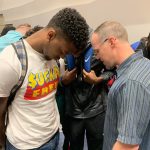 A Louisiana College staff member prayed with students at the close of the first day of the campus revival.