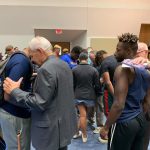 A Louisiana College staff member prayed with students at the close of the first day of the campus revival.