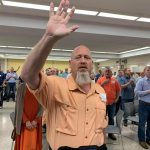 An E4 Preaching Conference participants raises his hands during a time of worship at the First Baptist Church in Pineville.