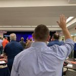An E4 Preaching Conference participants raises his hands during a time of worship at the First Baptist Church in Pineville.