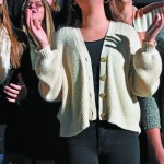 A Louisiana College student lifts her hands in praise during the opening session of the Annual Meeting.