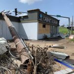 A fallen pole and other debris rest beside a business in Lake Charles. Brian Blackwell photo/Taken Sept. 2.