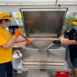Oklahoma Baptist Disaster Relief feeding unit team members stir a pot of green beans served to motorists at First Baptist Church in Moss Bluff. Brian Blackwell photo/Taken Sept. 2.