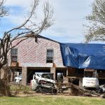 A blue tarp covered the damaged roof of a home near Cameron. Norm Miller photo/Taken Sept. 12.