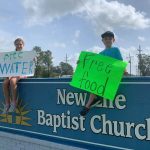 Youngsters encouraged motorists to pick up free food and supplies at New Life Baptist Church in DeRidder. Brian Blackwell photo/Taken Sept. 3