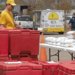 A Louisiana Baptist Disaster Relief volunteer greets a motorist in the feeding line at Trinity Baptist Church in Lake Charles. The church reported 152 storm victims have turned to Christ at Trinity from Aug. 28-Sept. 17. Steven Haney, Louisiana Baptist Communications, photo/Taken Sept. 2.