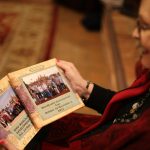 Cindy Walker displays her photo books from a 2011 WorldCrafts Development Tour. Her visits with WorldCrafts artisans around the world include a trip to Thai Country Trim in Bangkla, Thailand, WorldCrafts' very first artisan group. Walker affirmed that "it's very significant to know that we are playing a role in their lives by helping to provide them with income that is fair trade." Pam Henderson photo
